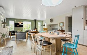 a kitchen and living room with a table and chairs at Cozy Home In Odder With Wifi in Odder