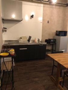 a kitchen with a sink and a counter top at Hotel Nagasaki Station in Nagasaki
