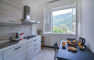 a small kitchen with a table and a window at 3 Bedroom Amazing Apartment In Avegno in Ageno