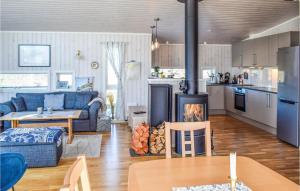 a kitchen and living room with a stove in a room at Nice Home In Manstad With Kitchen in Saltnes