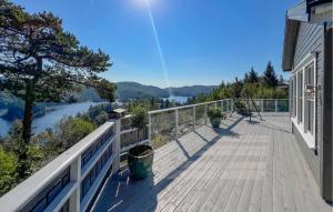 a balcony of a house with a view of a river at 3 Bedroom Nice Home In Lyngdal in Lyngdal