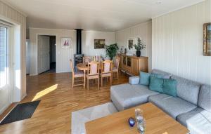 a living room with a couch and a table at 3 Bedroom Nice Home In Lyngdal in Lyngdal