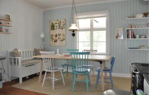 a kitchen with a dining room table and chairs at Gorgeous Home In Lennartfors Sverige in Lennartsfors