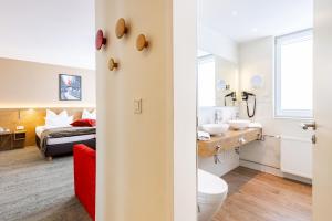 Cama ou camas em um quarto em Maingau Hotel