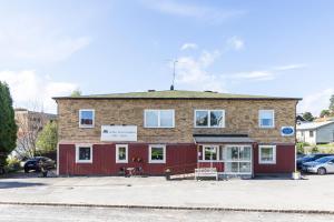 a red brick building with a red garage at Lenas Bed & Breakfast in Degerfors