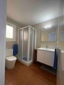 a bathroom with a shower and a toilet and a sink at Beach apartment in Calafell