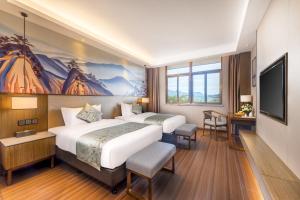 Postel nebo postele na pokoji v ubytování Millennium Resort Wuyishan