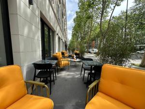 a patio with tables and chairs on a building at Graphik Montparnasse in Paris
