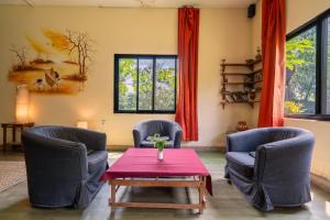 a living room with two chairs and a table at Nana Jungle Resort Near Chitwan National Park in Bharatpur