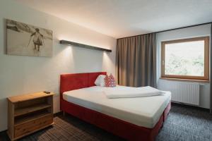 Łóżko lub łóżka w pokoju w obiekcie Panoramahotel Fliesserhof