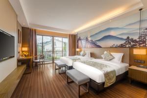 Postel nebo postele na pokoji v ubytování Millennium Resort Wuyishan