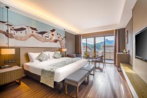 Postel nebo postele na pokoji v ubytování Millennium Resort Wuyishan