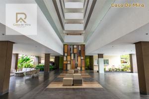 a lobby of a building with tables and chairs at Casa De Mira-Mesatierra Garden Residences in Davao City +46 photos