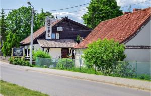 a building with a sign on the side of a street at Nice Apartment In Rydzewo With Wifi in Rydzewo