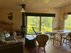 a living room with a table and a fireplace at Villa Aitti in Utsjoki
