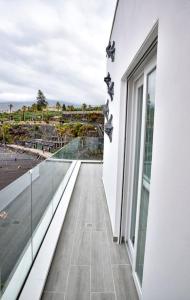 a balcony of a building with a view of the ocean at La Sirena Playa C in Puerto de la Cruz