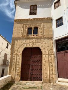 a building with a large wooden door in front at Casalar in Alhama de Granada
