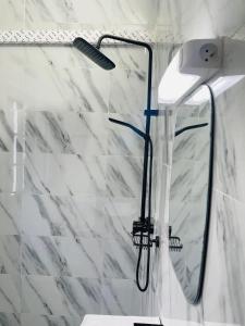 a shower with a glass window in a bathroom at Residence SVET in Kribi +47 photos