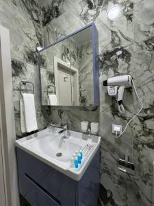 a bathroom with a sink and a mirror at Old City Samarkand Hotel in Samarkand +36 photos