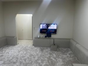 a living room with a couch and a flat screen tv at فيلا سعد in Riyadh