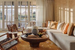 a living room with a couch and a table at Jumeirah Beach Hotel Dubai in Dubai