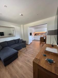 a living room with a couch and a table at Ferienhaus Kader in Eckernförde