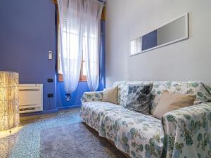 a living room with a couch and a window at Homeboutique in Cagliari