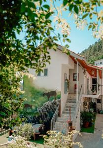a house with a painting of cows on the side of it at Tea House Gerês - T1 Hipericão in Geres