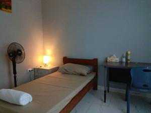 Postel nebo postele na pokoji v ubytování Fitz & Oritz Homestay