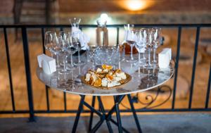 a table with wine glasses and a plate of food at Burki Castle & Cellar in Kvareli