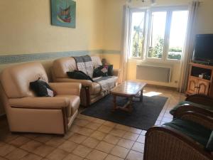 a living room with a couch and a coffee table at Ar vag in Ploubazlanec