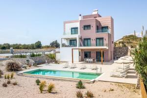 a house with a swimming pool in front of it at Villa Aurora in Faliraki