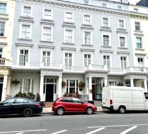 a white building with cars parked in front of it at Best Western Corona Hotel in London