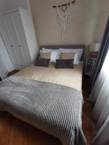 a bedroom with a large bed with two pillows at Apartament Comfort Sanok in Sanok