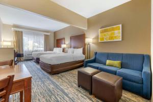 a hotel room with two beds and a blue couch at Comfort Suites Keeneland in Lexington +31 photos