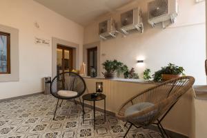 a living room with two chairs and a counter at Epic Boutique in Sibiu