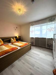 a bedroom with two beds and a large window at Mitten im Altmühltal - 110 qm in Solnhofen +23 photos