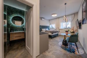 a bedroom with a bed and a bathroom with a mirror at Old Town - Bajor Studios 2 - Self Check-in and Parking in Kaunas
