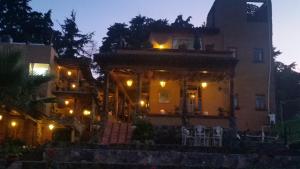 a house with lights on top of it at night at Eco Hotel Ixhi in Pátzcuaro