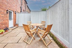 a wooden table and chairs on a patio at Host & Stay - The Beeches in Hayton +12 photos