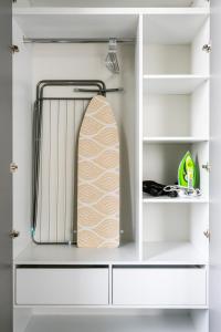 a surfboard is hanging in a white closet at Apartment KeyGo #0096 comfort and coziness in the city in Yerevan
