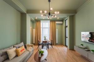a living room with a couch and a table at Apartment KeyGo #0096 comfort and coziness in the city in Yerevan