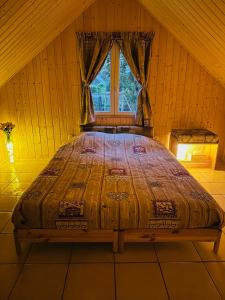 a large bed in a room with a window at Espace Piscine et SPA Villa des Cortins in Dierrey-Saint-Julien