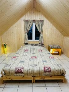 a large bed in a room with a window at Espace Piscine et SPA Villa des Cortins in Dierrey-Saint-Julien +38 photos