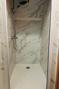 a shower with a glass door in a bathroom at Espace Piscine et SPA Villa des Cortins in Dierrey-Saint-Julien