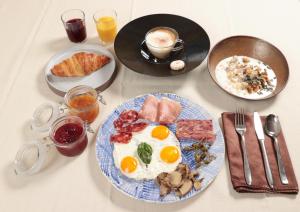 a table with a plate of breakfast foods and drinks at Saxida Wine Estate in Zalošče
