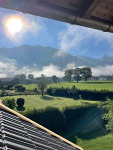 a view of a green field with mountains in the background at Ferienwohnungen Alpinum in Krün