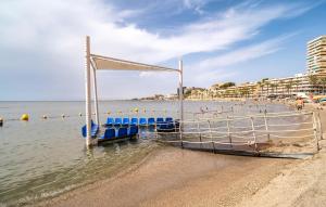 un barco sentado en el agua en una playa en Beautiful Apartment In Aguadulce, en Aguadulce 9 fotos más