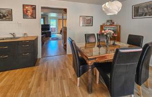 a kitchen and dining room with a table and chairs at Cozy Home In Kongsberg in Kongsberg