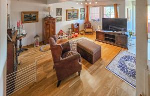 a living room with a couch and a television at Cozy Home In Kongsberg in Kongsberg